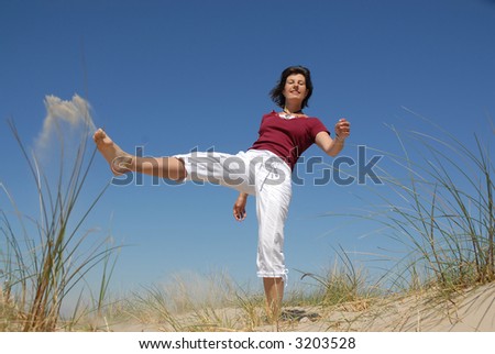karate kick by a girl on the beach