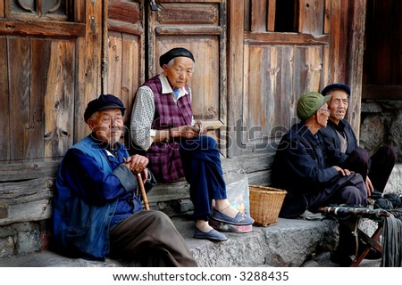 old chinese men and women socializing on the street