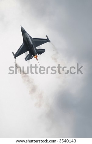f16 fighter airplane flying on light cloudy background to use as wallpaper or dvd cover