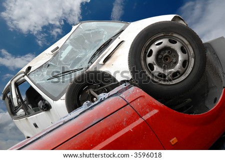 car crash with a red and white car and a blue cloudy sky
