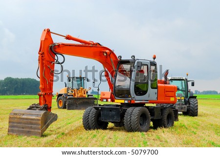 composition of farming machinery with a tractor, bulldozer and excavator on farmland background