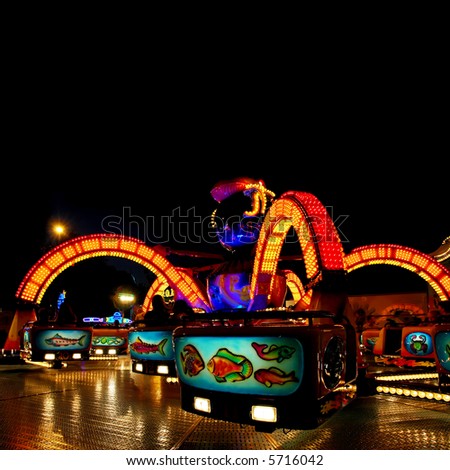 colorful lit octopus ride on a funfair at night
