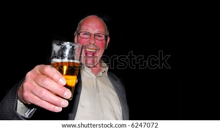 cheers! happy man with red cheeks drinking a beer at a party isolated on black background