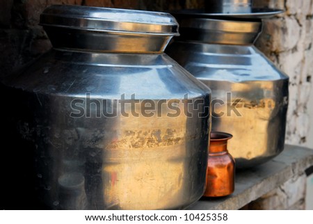 tin pots in a primitive indian kitchen
