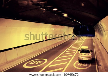 Car driving through tunnel in night time
