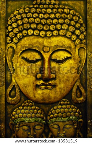 Golden south east asian buddha faces on black background