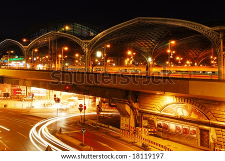 Beautiful lit railway station of Cologne at night with moving car lights in the tunnel underneath