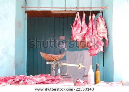 Colorful butcher shop with vintage scale and red meat in colonial town Baracoa, Cuba