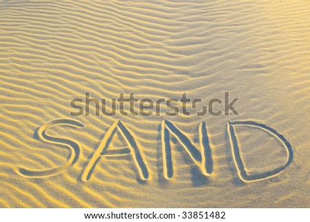 the word sand, written in sand
