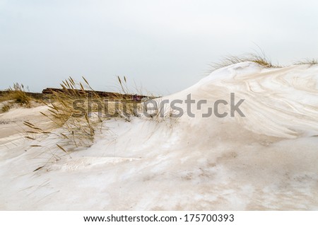 sand covered snow dunes at the historic building prora from nazi era in germany, parts of the port and pier, rugia island, baltic sea