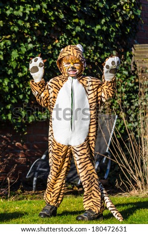 young boy dressed up like a tiger in an handmade costume