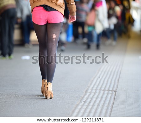 Unlucky woman with torn sock walking on platform
