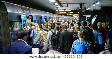 STOCKHOLM, SWEDEN - AUGUST 30 Subway train passengers crowding to get on and off subway station platform T-centralen, the hub of the Stockholm SL transportation system in Stockholm on August 30, 2012.