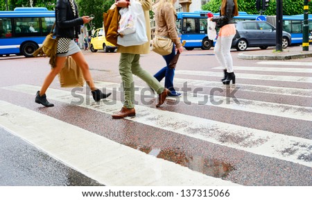 People on rain wet zebra crossing