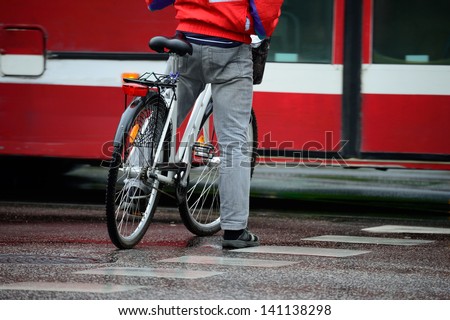 Man on bike, waiting, in traffic