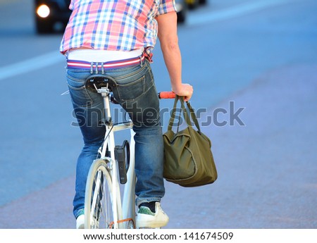 Person on bike seen from behind.