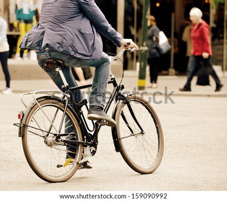 Man On Bike In Traffic