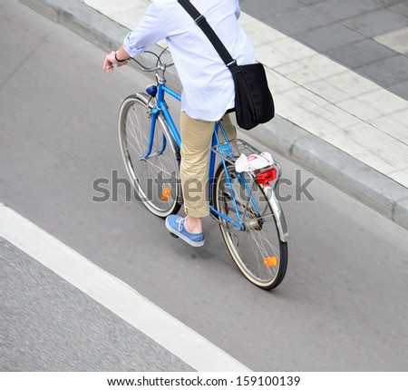 Man on bicycle on his way home from work, in bike lane