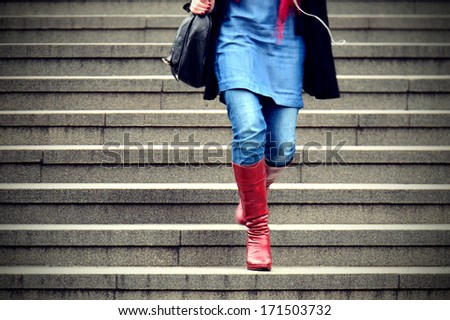 Woman walking down the stairs in the winter