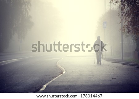 Woman walking in the fog