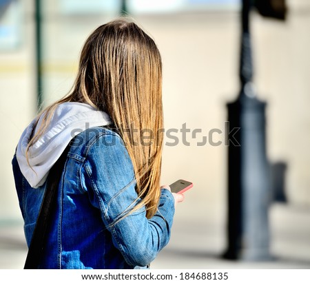 Blonde head in silhouette with phone, Swedish woman