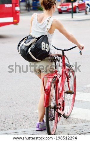 Woman and red bike.