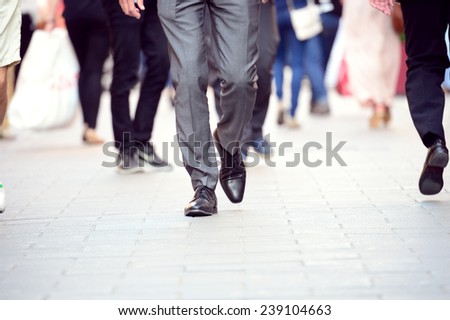 Business man in suit walking on sidewalk