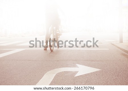 Woman on bike into the bright
