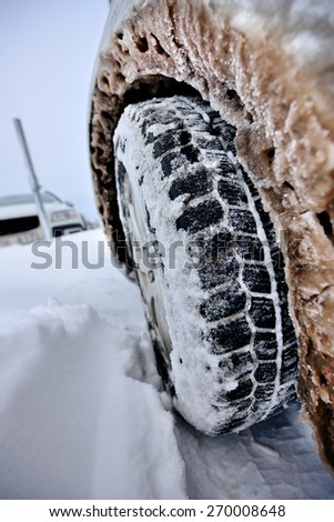 Close up of icy winter car wheel