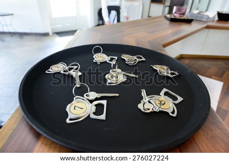 Hotel keys on tray on table