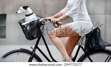 Side shot of woman and dog on bike