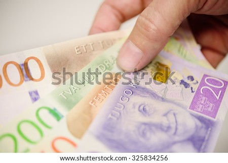Hand holding new swedish bank notes fanned out. NOTE: the new 2015 model.