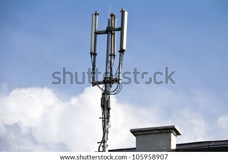 cellular communication aerial on a building roof top