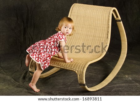 Dear girl sits on the chair