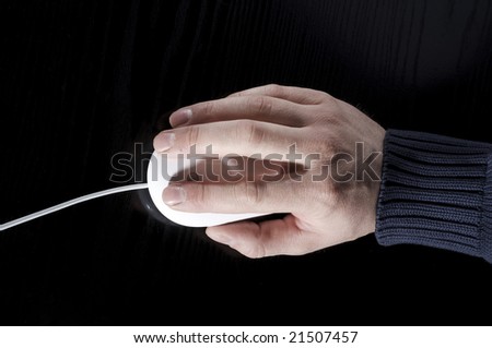 The man's hand works with the white mouse