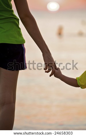 The small daughter holds mum by the hand on a decline