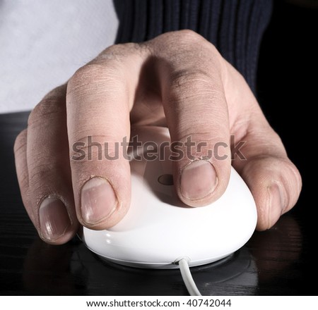 The man's hand works with the white mouse