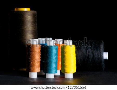 Spools of thread on black background