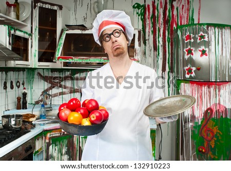 Thoughtful cook with apples in the painted kitchen