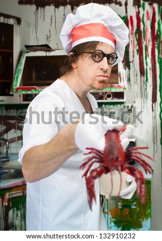 Crazy cook with lobster in the painted kitchen