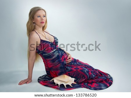 Portrait of pregnant blonde with sea shells
