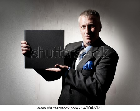 Serious businessman with business book