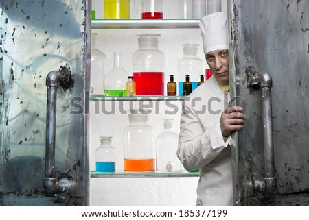 Chemist looks from behind the door of the laboratory