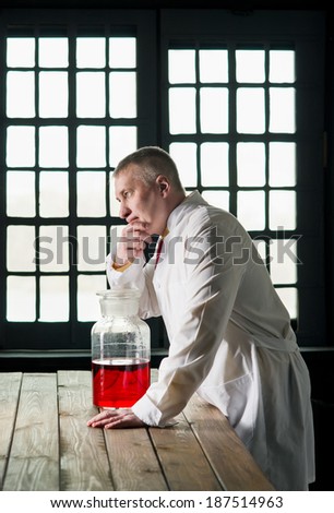 Physician with the bottle at the window