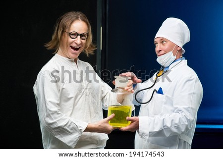 Doctor and patient holding a bottle medicine