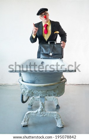 Man in suit stands near a art bath