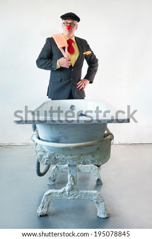 Man in suit stands near a bath with washcloth