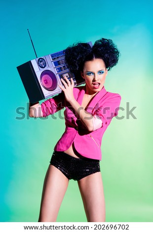 Merry girl with a tape recorder on the disco