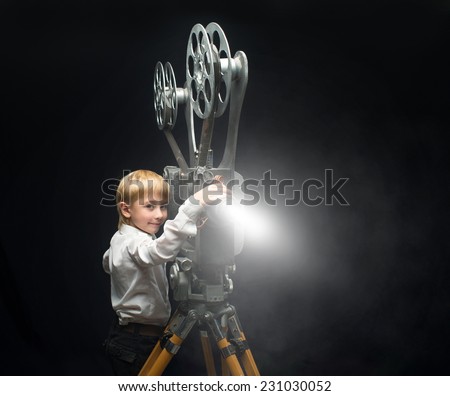 Little boy with a film projector