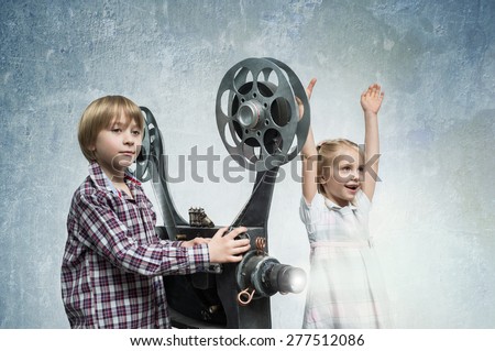 Girl and boy with a film projector